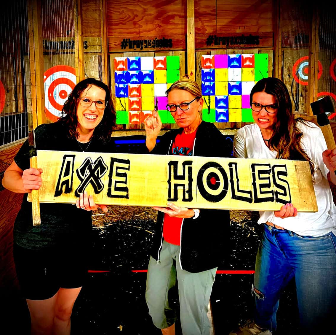 Friends having fun throwing axes